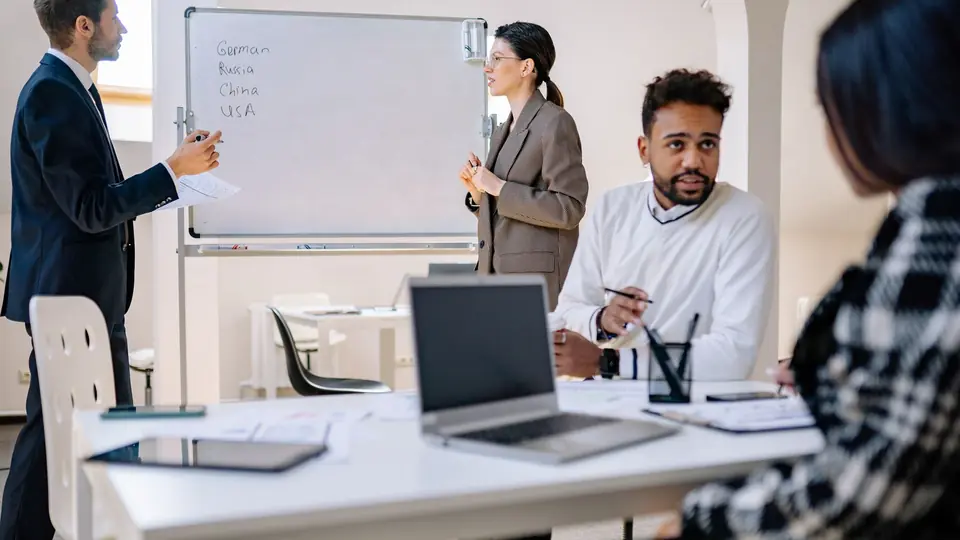 Team discussing a strategy at a whiteboard